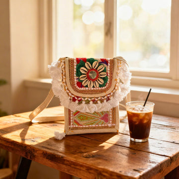 Ivory Mirror & Shell Tassel Sling Bag by Suryatra